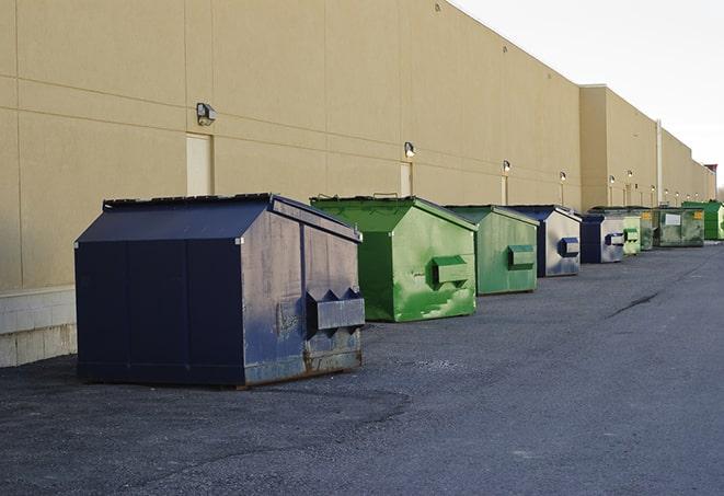 construction crew disposing of building materials in large bins in Gibson, LA